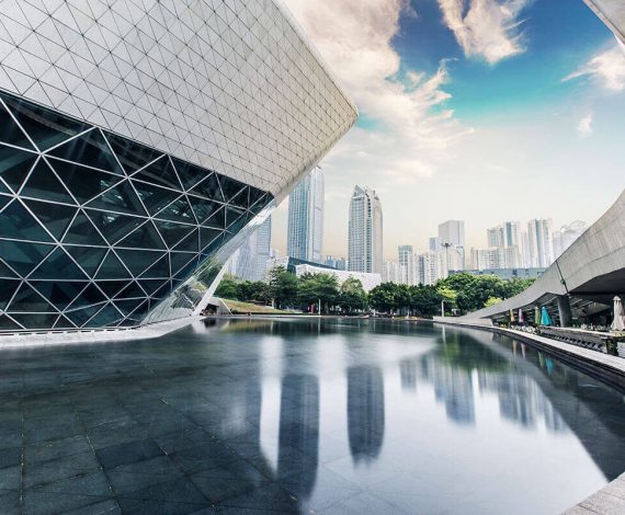 Modern architecture with city skyline and reflection.